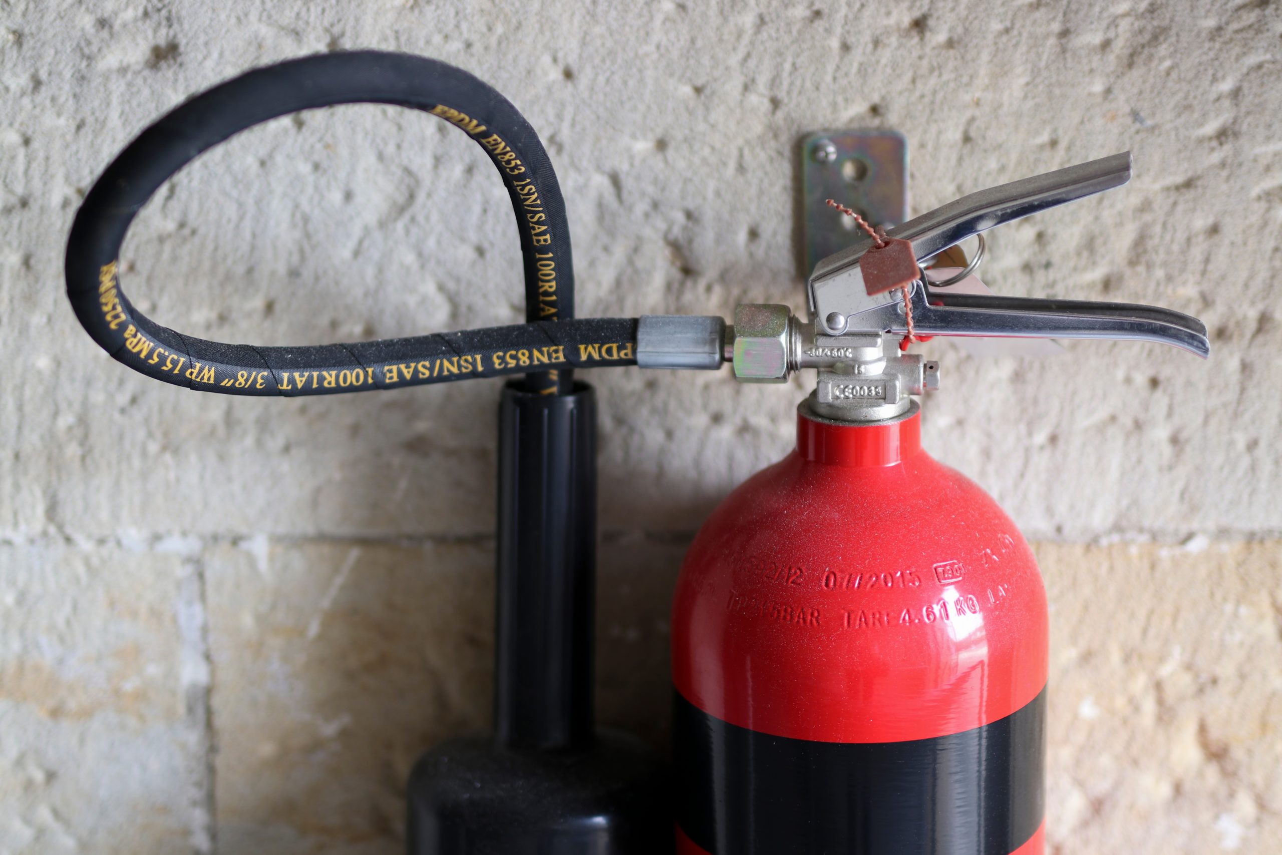 close-up-view-of-a-red-and-black-fire-extinguisher-6F4LKUT